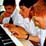 Photo - pupils playing piano together